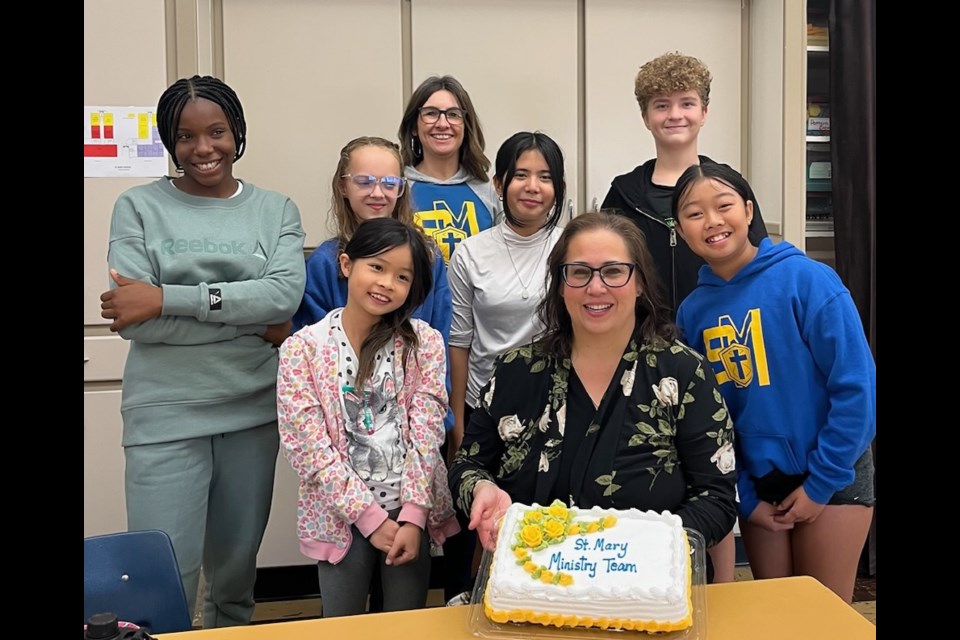 Lisa Busta, chaplain for Holy Trinity Catholic School Division (front, centre), gathers with students from St. Mary School to celebrate their ministry team. Photo submitted