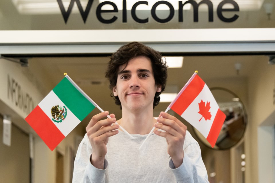 International student holds the Mexican and Canadian flags (Juanmonino-iStock-Getty Images)