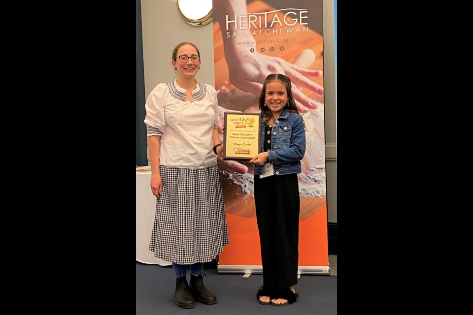 Kenzie Crocker (right), a Grade 5 student at Sunningdale School, accepts the Queen Elizabeth II Platinum Jubilee Award during the recent provincial Heritage Fair program. She also placed fifth overall during the event. Photo courtesy Heritage Saskatchewan