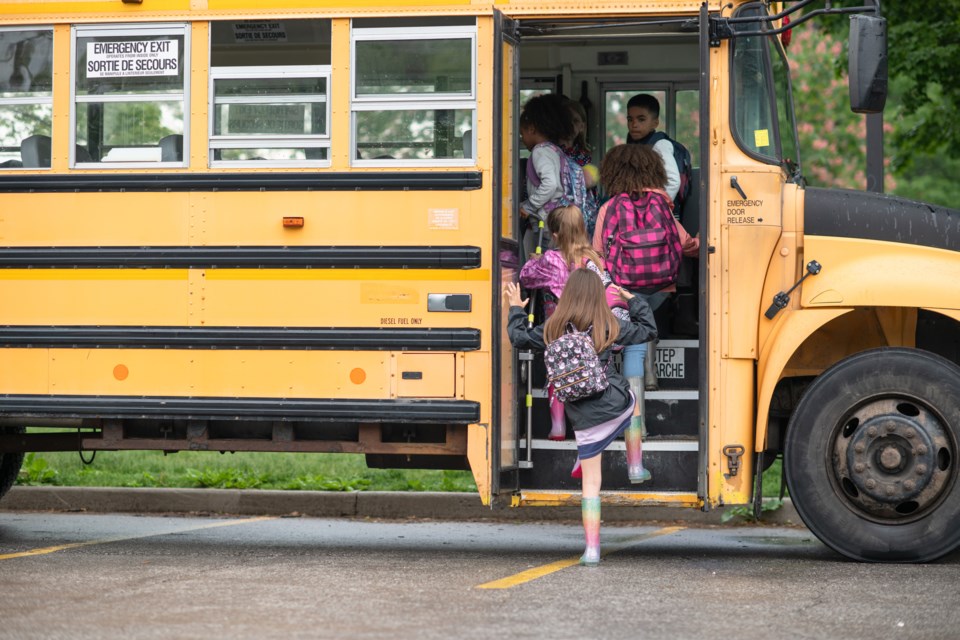 kids getting on school bus