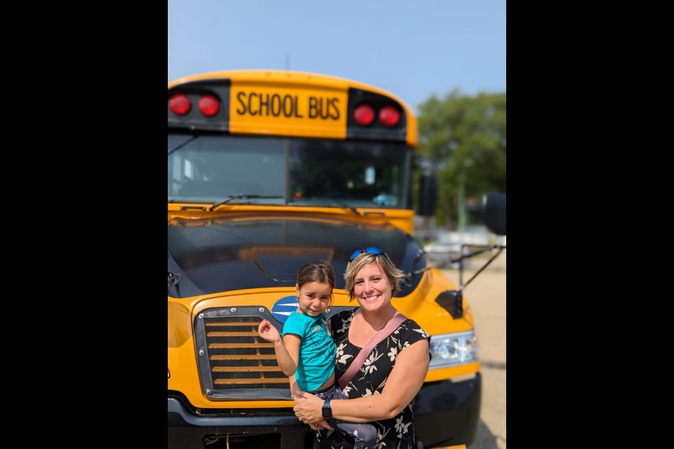 Laurie Freeman and her daughter Ibie - Ibie was excited to see the buses and police officers, take a ride on the school bus, and especially to start school this September