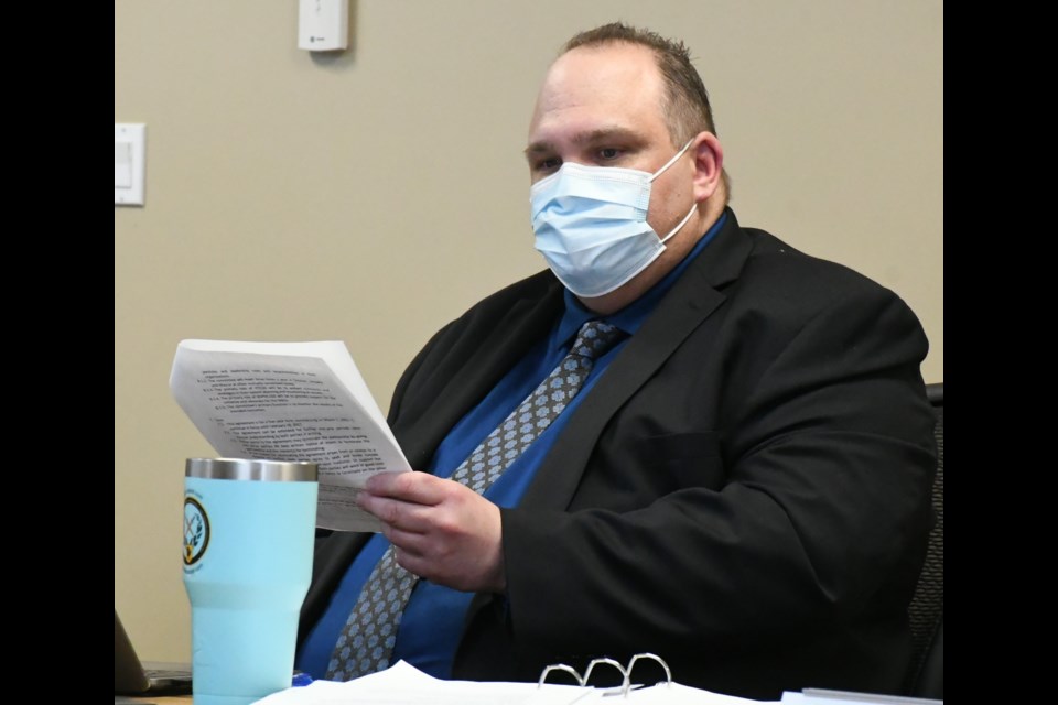 Ward Strueby, director of education for Holy Trinity Catholic School Division, reads a part of the memorandum of understanding (MOU) during the board meeting. Photo by Jason G. Antonio