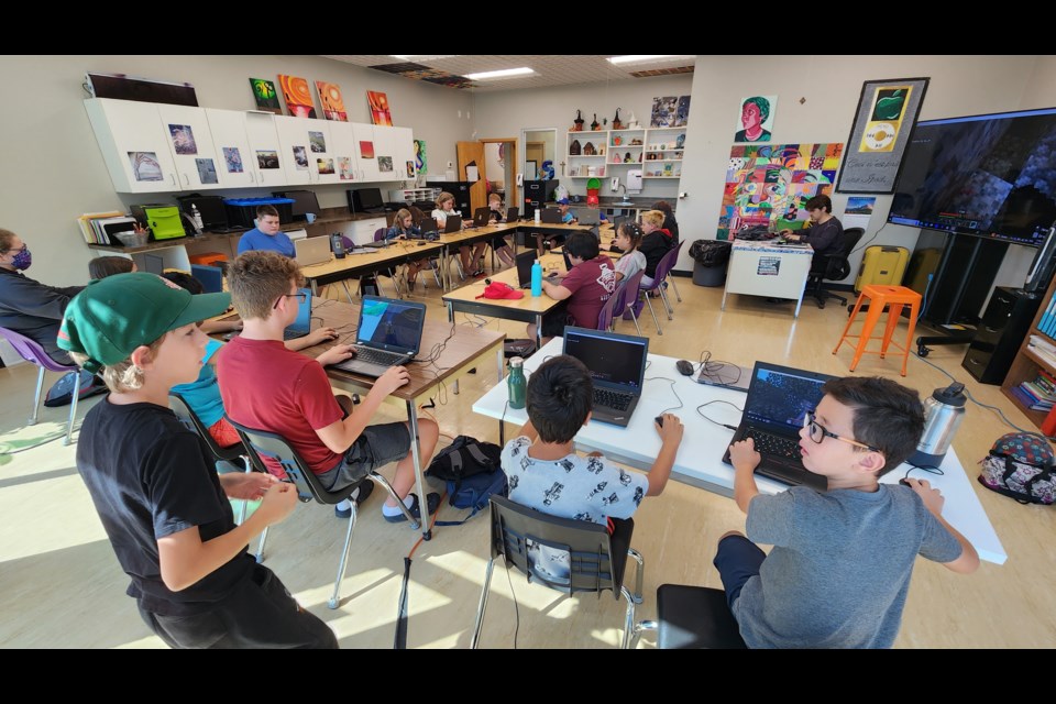 Students work on a coding project together at the Nanan STEM Academy 'STEAM' summer camp