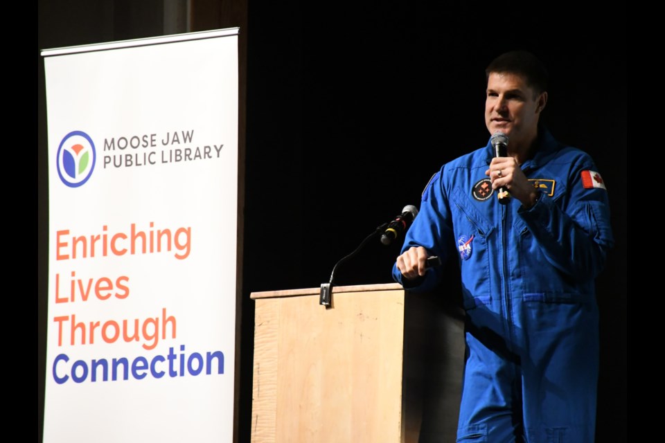 Col. Jeremy Hansen, a Canadian astronaut and pilot in the Royal Canadian Air Force, speaks to hundreds of Moose Jaw-area students at A.E. Peacock Collegiate about the Royal Canadian Air Force's centennial this year. Photo by Jason G. Antonio