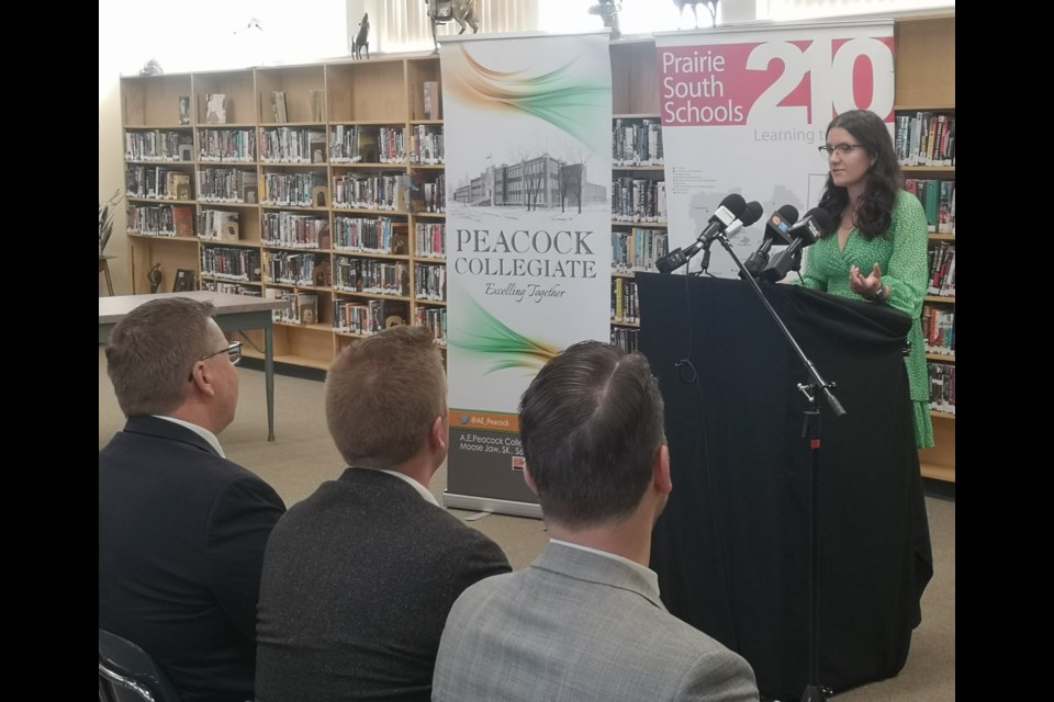 Peacock Collegiate student Abby Fuhr (at podium) speaks before Premier Scott Moe (front left), Jeremy Cockrill, and Tim McLeod (front right) April 25.