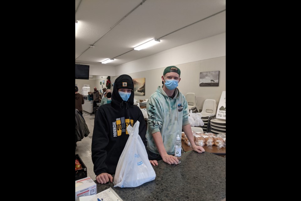 Members of Peacock's boys senior basketball team serve meals at Riverside Mission