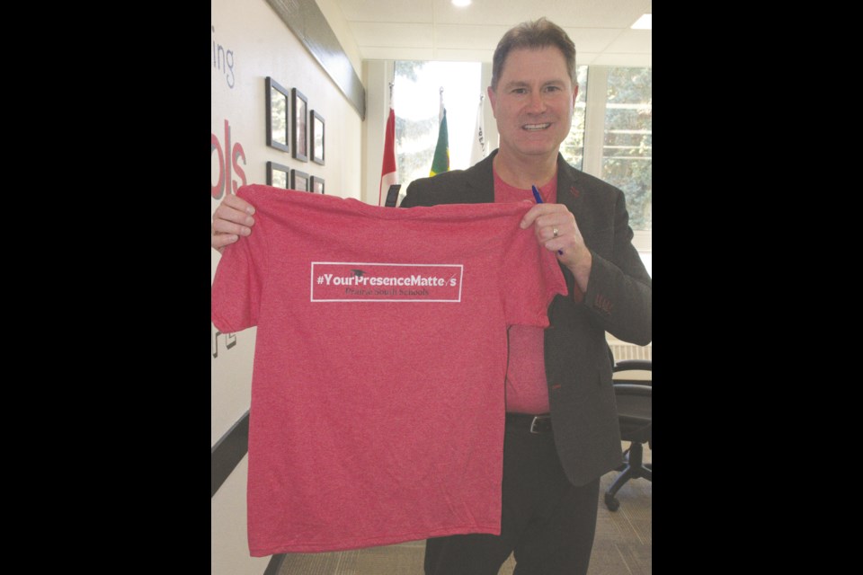 Ryan Boughen, education director for Prairie South School Division, holds a T-shirt promoting the organization's attendance matters-focused campaign. Photo by Jason G. Antonio