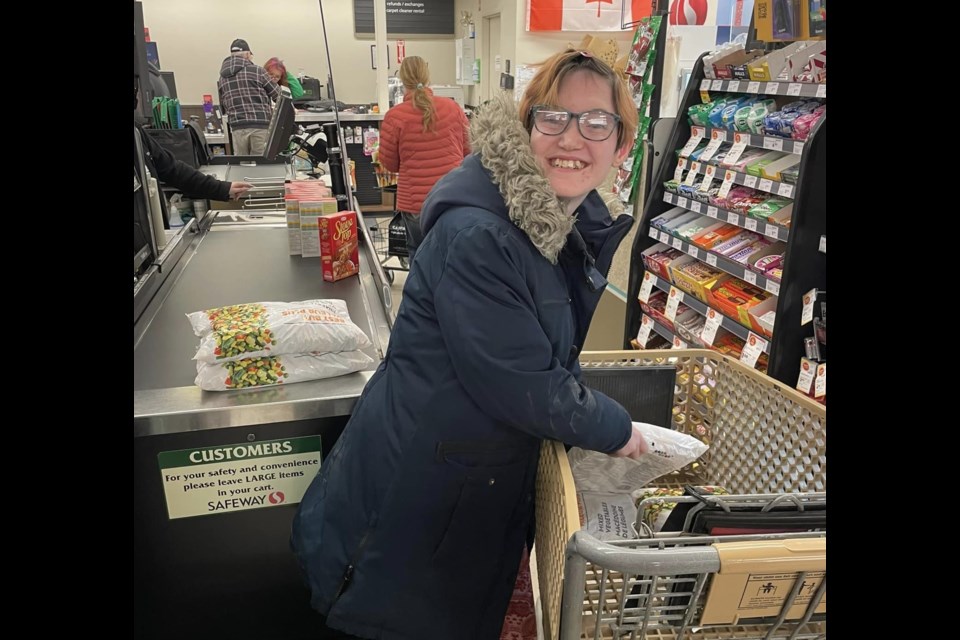 Shavon helps unload the cart while shopping at Safeway prior to the Dec. 15 banquet.