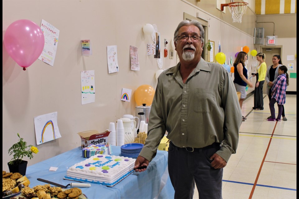 Dwayne Sisetsky cuts his retirement cake, after 30 years as a caretaker at St. Mary’s School.