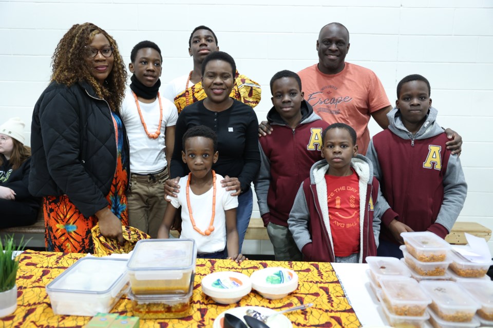 Ololade Kassim (centre) and her Nigerian family with their Jollof rice and grilled chicken