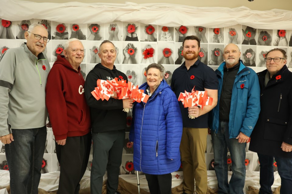 From l-r:  Lyle Johnson, Ken Hawkes, Dave Osberg, Joyce Walter, Sunningdale teacher, Phil Adkins, and Robb Nesbitt stand in front of memorials made by the students