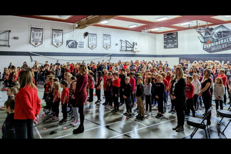 Sunningdale Remembrance Day Assembly students, staff, and guests sing the national anthem