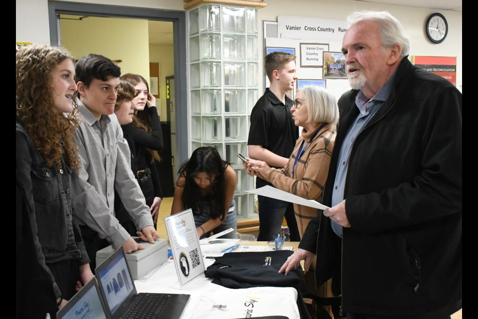 Rob Clark, CEO of the chamber of commerce (right), speaks with Vanier business students during the class' Junior Achievement launch event. Photo by Jason G. Antonio