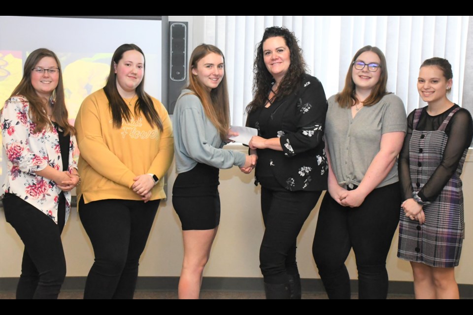 Students from the Scrub ‘N’ Scrunch business venture present a cheque for $162 to Marta Woodrow (third from right), a board member with the Kinsmen Inclusion Centre. Photo by Jason G. Antonio