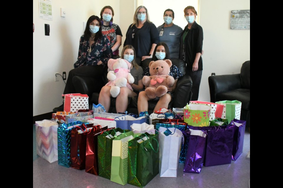 A group of students from Vanier Collegiate's Grade 11 Catholic Studies class drops off 40 gift bags filled with 54 stuffed toys at the pediatric ward at Dr. F.H. Wigmore Regional Hospital on May 5. In back, from left, are Brooklyn Artavia, Mia Donaldson, teacher Monique Byers, pediatric RN Bonnie Nelson, and ward manager Judy Wicharuk. Seated, from left, are Olivia Geradts and Bethany Jones. Photo by Jason G. Antonio