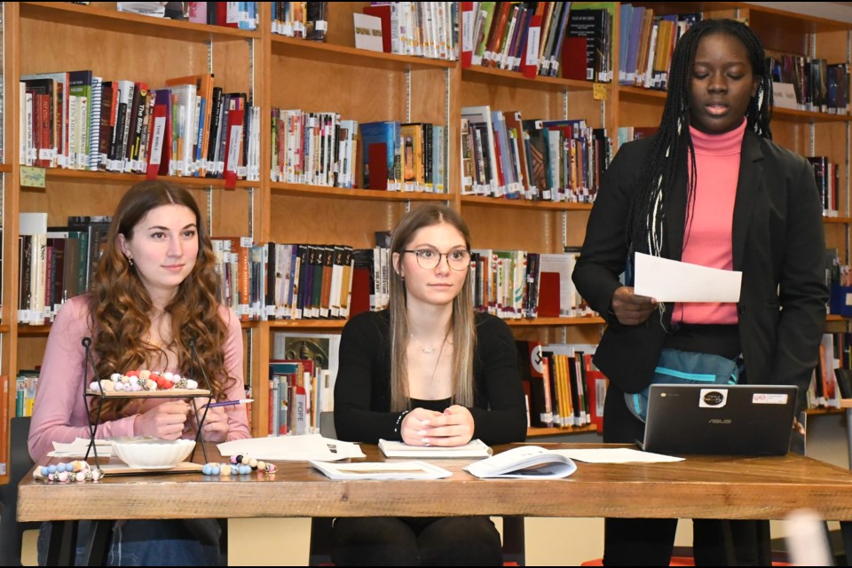 Adysen Moser, Leah Crossland and Timi Konu co-chair the board of director's meeting. Photo by Jason G. Antonio