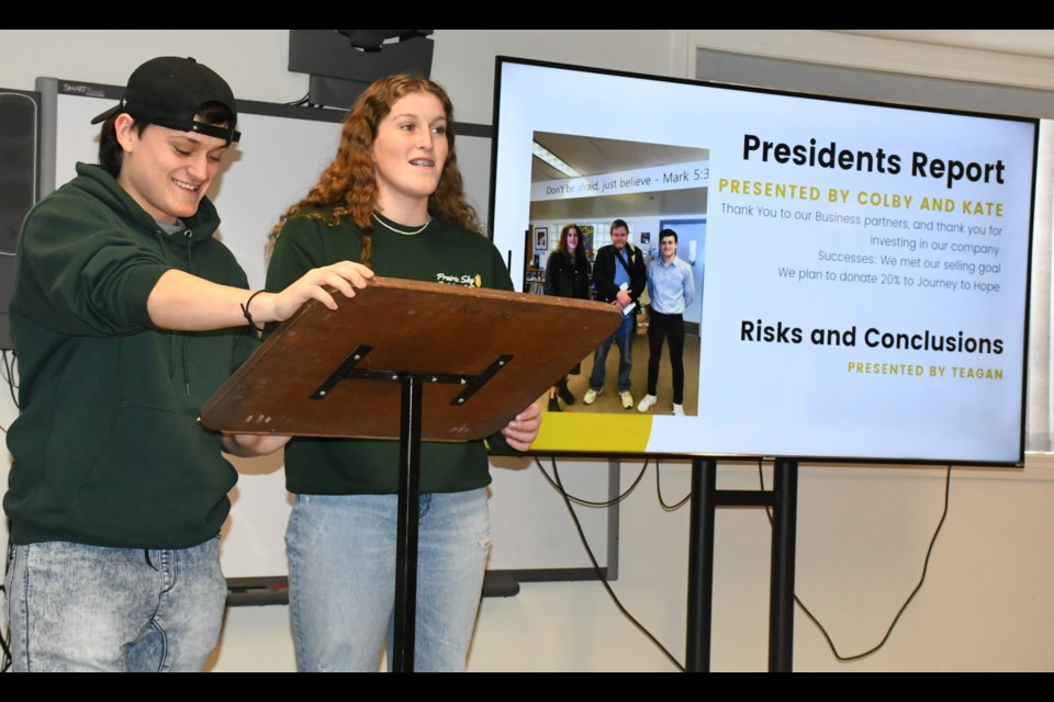 Colby Clark and Kate Waldenberger, co-presidents of Prairie Sky clothing, give their reports. Photo by Jason G. Antonio 