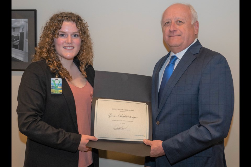 Grace Waldenberger, a Grade 12 student at Vanier Collegiate, receives an award from Agriculture Minister David Marit for her essay about transparency in the industry. She also received a $2,000 scholarship. Photo courtesy Ministry of Agriculture 