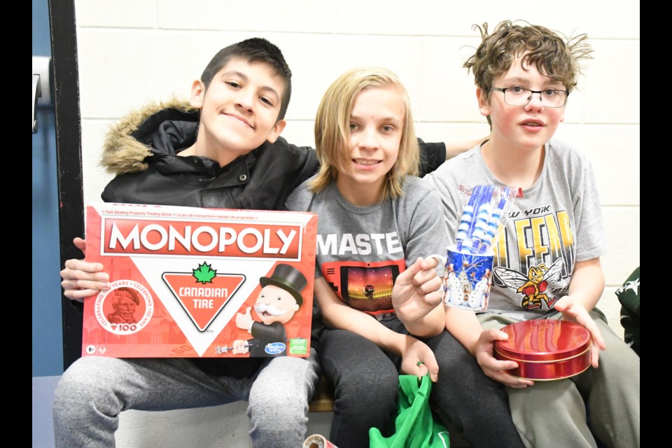 Westmount School students display some of the gifts they bought during the Christmas Store event. Photo by Jason G. Antonio