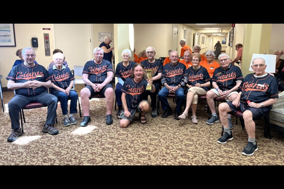 The Mulberry Giants, beanbag baseball champions of Atria Mulberry Estates, show off the travelling trophy after their victory against Queen Victoria Estates.