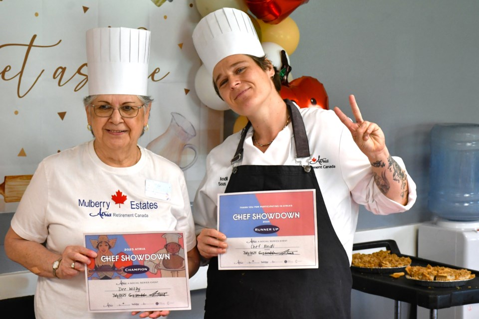 Chef Dee, left, and Chef Andi, right, hold up their certificates for first and second place following the apple pie bake-off held recently at Atria Mulberry Estates.