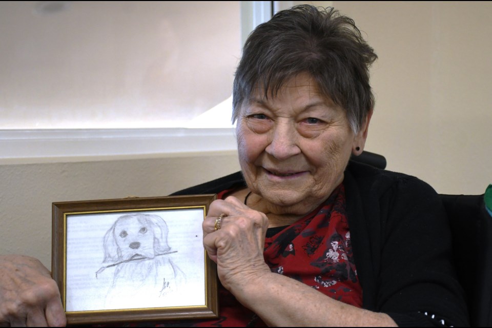 Shirley Nielsen holds up one of her pencil sketches on March 20.