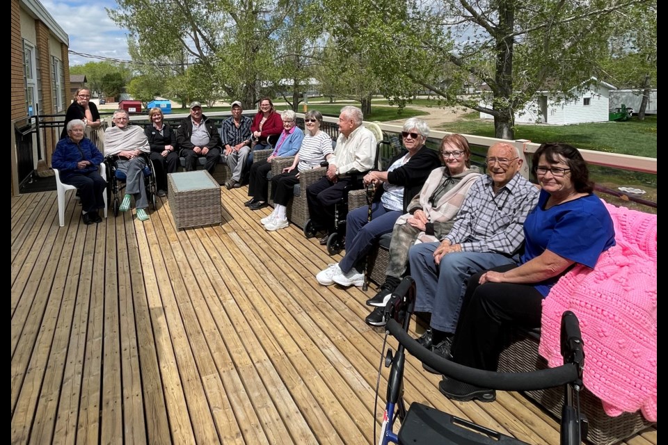 Residents and staff of Iver Main enjoy the new patio donated by Palliser Plains Co-op, as managers Helen Watson and George Hartell served lunch on Thursday, May 18, 2023