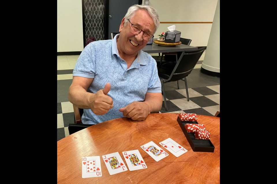 Hugh Millar celebrates after winning a game of Texas Hold'em with a royal flush at the Timothy Eaton Gardens. A royal flush is the highest hand a player can achieve. Photo courtesy Earl Burrard 