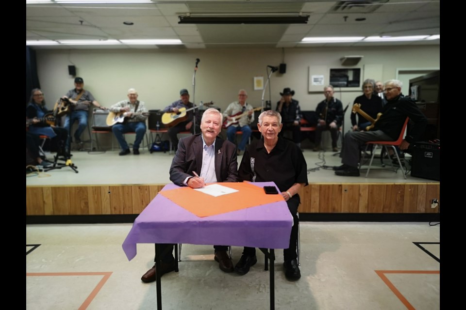 Mayor Clive Tolley (left) signed the proclamation that made Senior's Week official, with Earl Berard (right) representing MJDSCA.