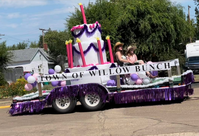 A birthday cake float for the town drives in the parade on Saturday