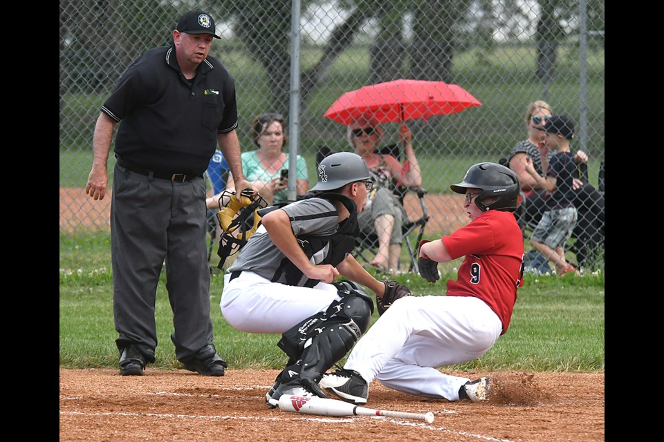 Canucks baserunner Rylan Caplette-Tarrant slides home but would be tagged out.