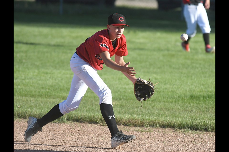 Canucks shortstop Max Simmons tosses to second to start at attempted double play.