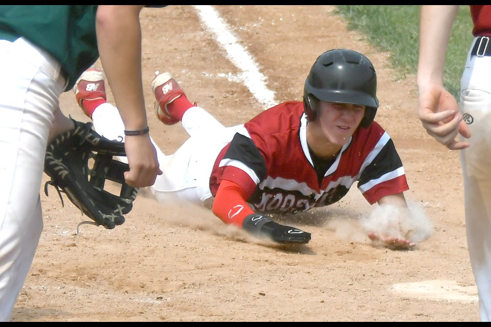 Tate Macdairmid slides home with the game-tying run for the Canucks in the bottom of the seventh.