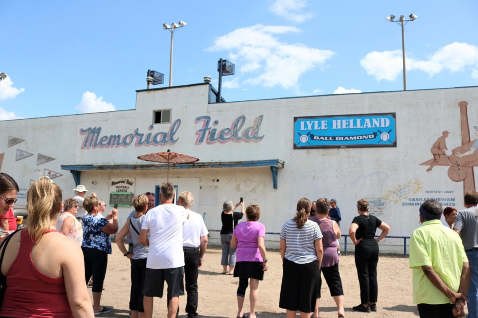 Gathering to admire the new sign. Photo by Scott Hellings