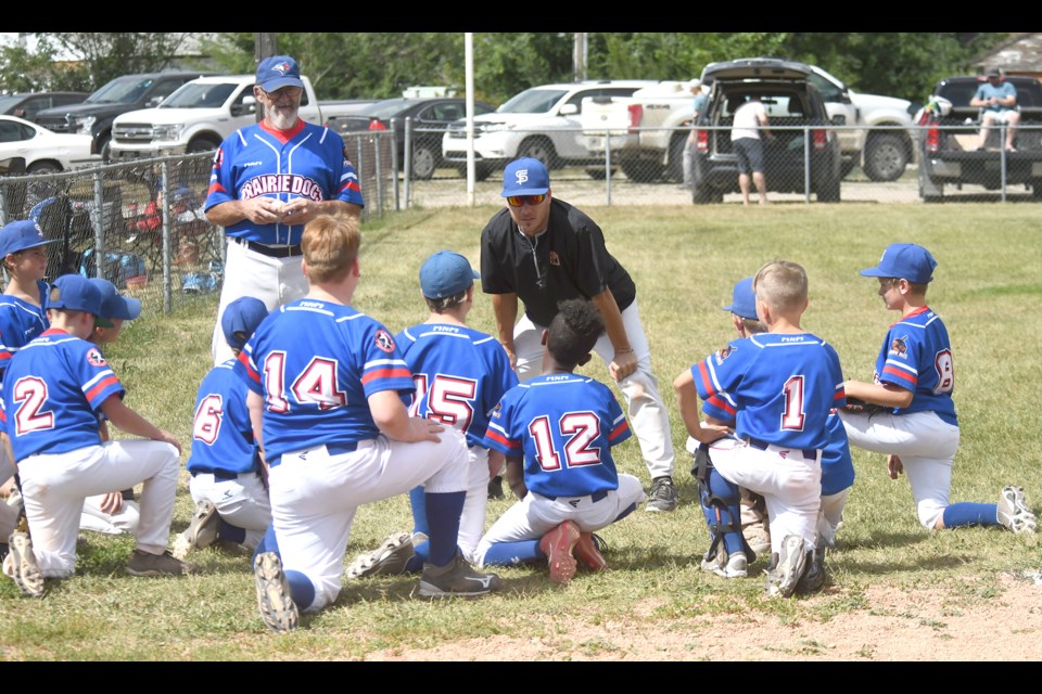 Coaches Craig Flanagan and Charlie Meacher chat with the Prairie Dogs after their first win over Lumsden.