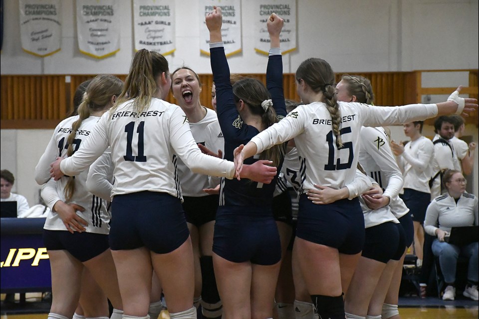 The Briercrest College Clippers women’s volleyball team celebrate after their win over Ambrose.