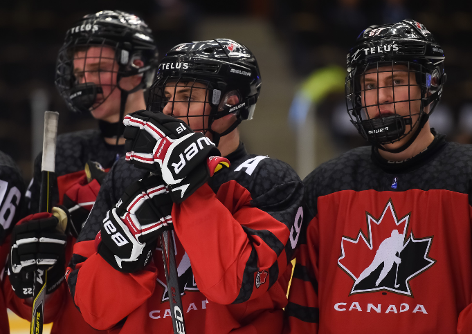 Team Canada’s Samuel Poulin and Nathan Legare look on after falling 5-2 to the United States in the bronze medal game. Photo by Steve Kingsman / HHOF-IIHP Images