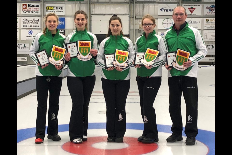 Skylar Ackerman, third Madison Johnson, second Chantel Hoag, lead Samantha McLaren and coach Patrick Ackerman with their Saskatchewan crests.