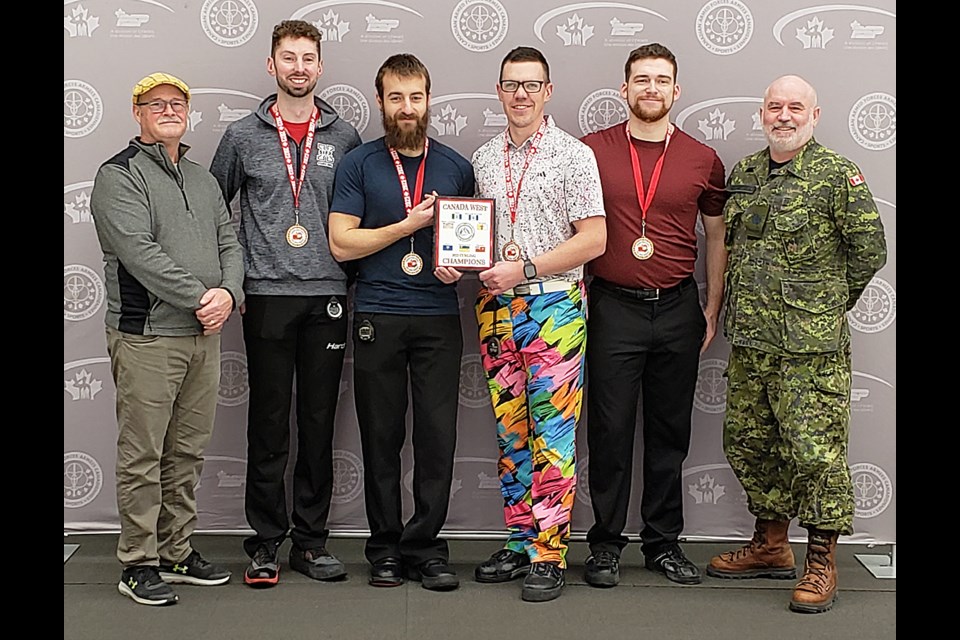 The Kyle Walker rink from 4 Wing Cold Lake accepts their champions plaque and gold medals after winning the final of the CAF Canada West Curling Championship.