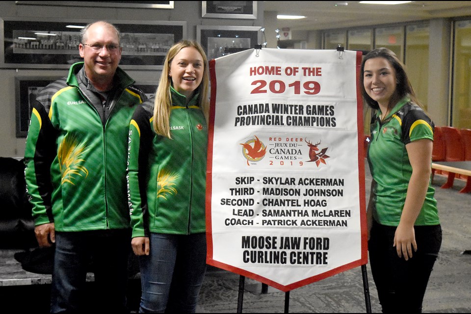 Coach Patrick Ackerman, Skylar Ackerman and Chantel Hoag were on hand during the Curl Moose Jaw Championship Banquet for the unveiling of their Canada Games provincial championship banner.