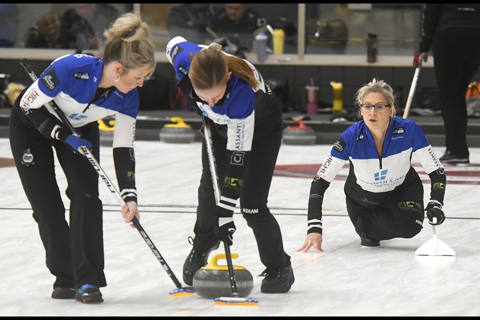 Candace Newkirk watches the line as Shalon Fleming and Jasmine Kerr sweep for Sheri Orsted.