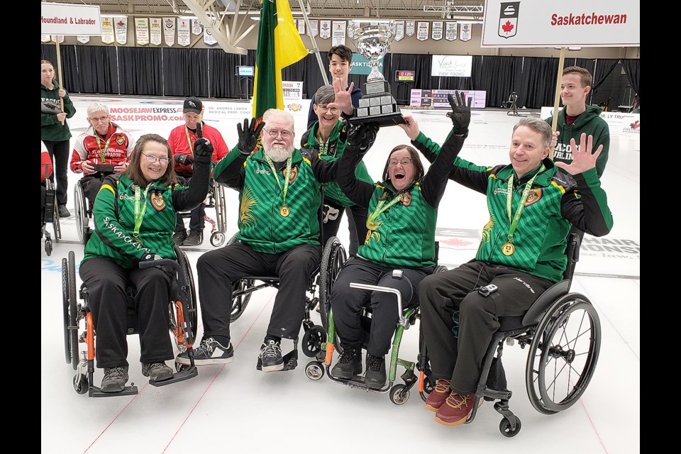 Saskatchewan 1's Sheryl Pederson, Moose Gibson, Lorraine Arguin, Marie Wright and Gil Dash celebrate after winning the 2024 Canadian Wheelchair Curling Championship.