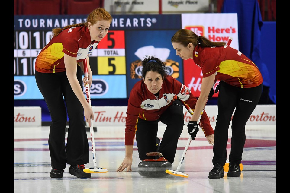 Kaitlin MacDonald and Alison Griffin keep an eye on Lori Eddy's final shot against Canada.