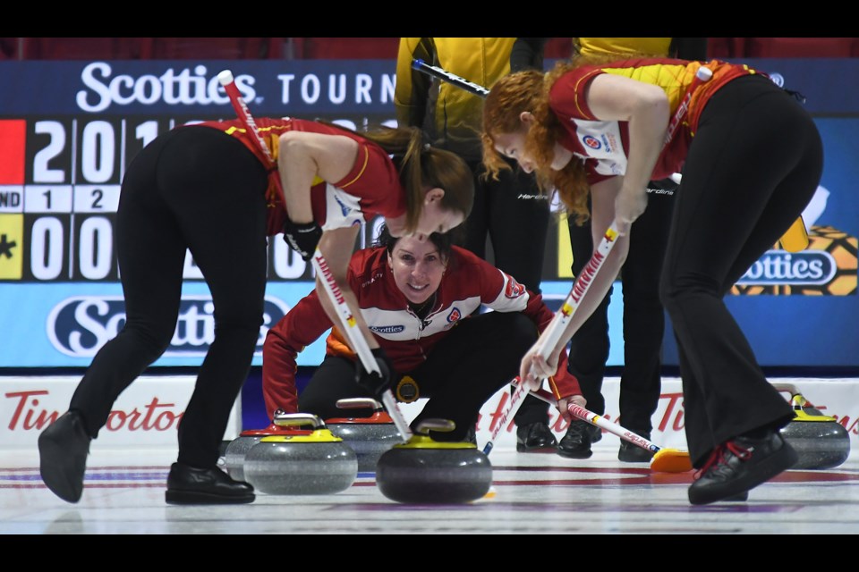 Lori Eddy calls to her sweepers.