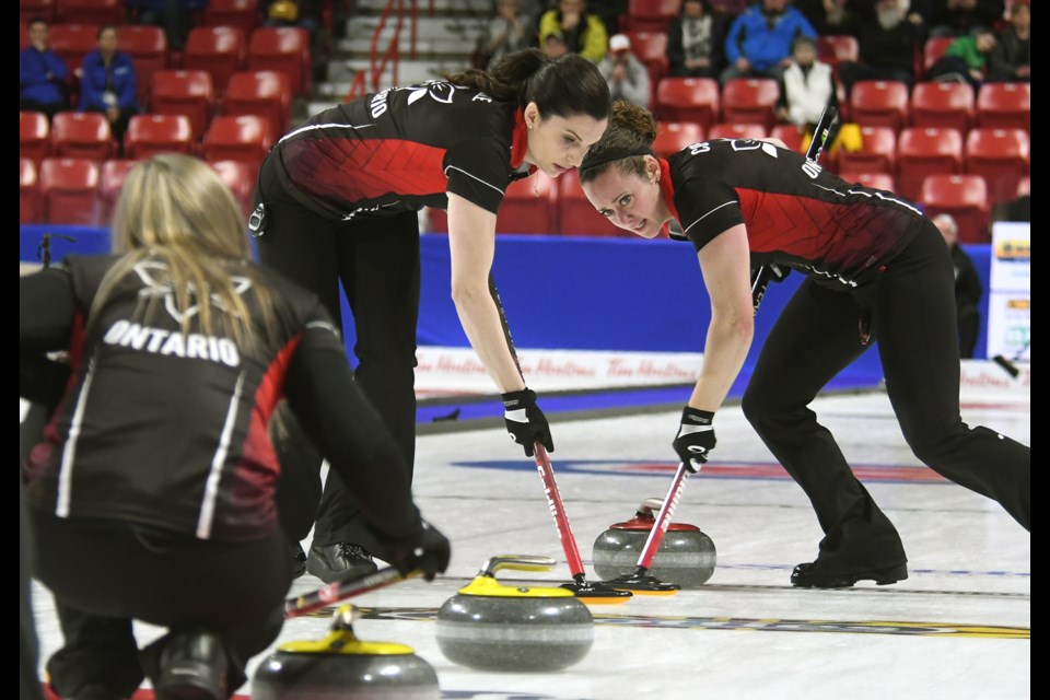 Ontario's Lisa Weagle and Joanne Courtney sweep as Rachel Homan calls lline.