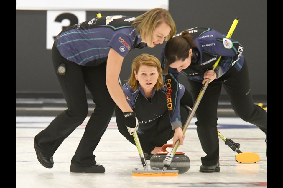 Christy Gamble and Danielle Sicinski sweep a shot for Deanna Doig during the Moose SWCT stop.