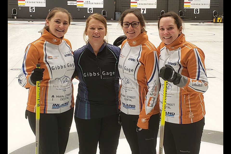 Penny Barker, third Deanna Doig, second Jenna Enge and lead Danielle Sicinski gather for the customary post-championship photo.