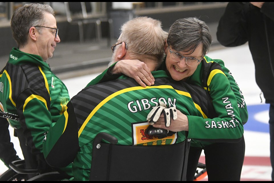 Coach Lorraine Arguin hugs Moose Gibson as their win in the gold medal final at the 2024 Canadian Wheelchair Curling championship.