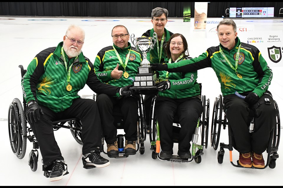 Saskatchewan 1 with their gold medals and the Canadian Wheelchair Curling Championship trophy. Moose Gibson, Darwin Bender, coach Lorraine Arguin, Marie Wright and Gil Dash.