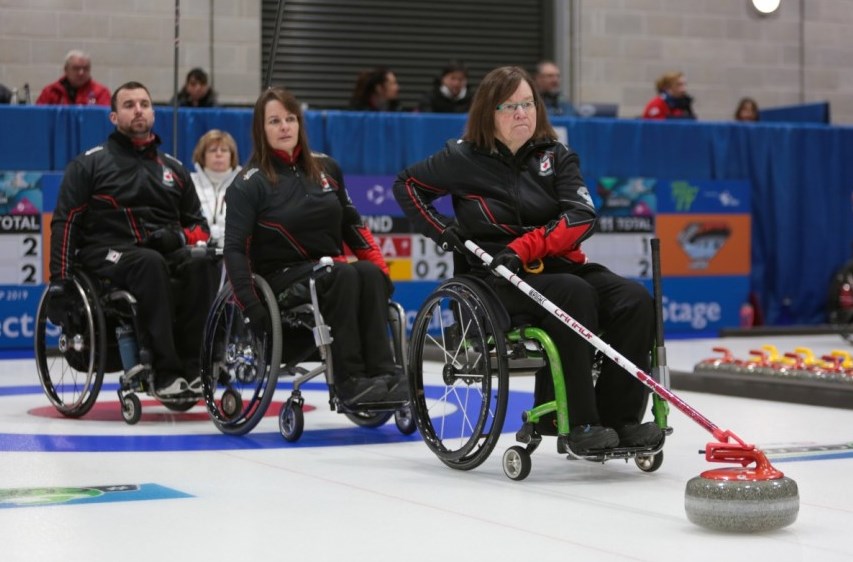 Moose Jaw's Marie Wright delivers a shot as third Ina Forrest and skip Mark Ideson look on. Richard Gray/WCF photo